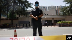 Chinese police officers guard the former United States Consulate that was closed in Chengdu in southwest China's Sichuan province on Monday, July 27, 2020. Chinese authorities took control of the former U.S. consulate in the southwestern Chinese…