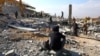 A man sits amid rubble at a site damaged in an Israeli strike on the town of Al-Ain in the Baalbek region, Lebanon, on Nov. 6, 2024.