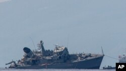 Α damaged Greek mine sweeper is towed near the port of Piraeus, Oct. 27, 2020. 