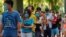 People queue up to vote in Hong Kong, July 12, 2020, in an unofficial primary for pro-democracy candidates ahead of legislative elections in September. 