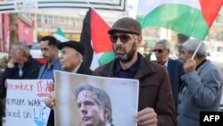 FILE - Palestinians protest against a visit by US Secretary of State Antony Blinken to Israel and the Palestinian territories in the West Bank city of Ramallah on November 30, 2023.