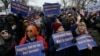 FILE - Labor union activists rally in support of federal workers during a protest in Washington, Feb. 11, 2025. Despite the protests, President Donald Trump signed an executive order Tuesday telling agency leaders to plan for "large-scale reductions in force." 