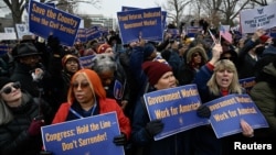 Labor union activists rally in support of federal workers during a protest on Capitol Hill, in Washington