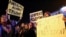 Anti-Trump protesters hold banners during a demonstration at Puerta del Sol Square in Madrid, Spain, Dec. 2, 2016. 