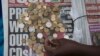 A newspaper vendor counts out change for a customer in Durban, September 8, 2015. South Africa's rand firmed more than 1 percent against the dollar, recovering from record lows in the previous session as bets on a rate hike in United States faded Nov, 26, 2021. 