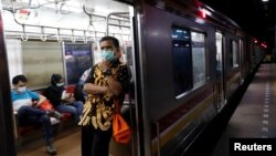 Seorang pria mengenakan masker pelindung wajah di dalam kereta commuter di tengah pemberlakuan Pembatasan Sosial Berskala Besar (PSBB) untuk mencegah penyebaran virus corona di Jakarta, 21 April 2020. (Foto: Reuters)