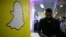 FILE - The logo of messaging app Snapchat is seen at a booth at TechFair LA, a technology job fair, in Los Angeles, California.