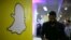 FILE - The logo of messaging app Snapchat is seen at a booth at TechFair LA, a technology job fair, in Los Angeles, California.