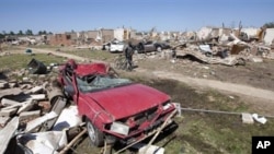 Calvin Smith of Tuscaloosa, Alabama, pushes his bike past tornado demolished homes in Tuscaloosa, Alabama, April 29, 2011