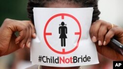 FILE - A woman protests against underage marriages in Lagos, Nigeria, July 20, 2013. The African Union is to convene a summit in Zambia this week with a view to ending child marriage. 