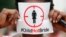 FILE - A woman protests against underage marriages in Lagos, Nigeria, July 20, 2013.