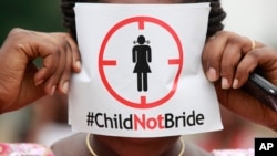 FILE - A woman protests against underage marriages in Lagos, Nigeria, July 20, 2013. The African Union is to convene a summit in Zambia this week with a view to ending child marriage. 