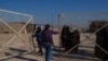 FILE - Members of the Syrian Democratic Forces open a gate of the al-Hol detention camp in northeastern Syria's Hassakeh province, where tens of thousands of mostly women and children linked to the Islamic State group have been living, Jan. 30, 2025.