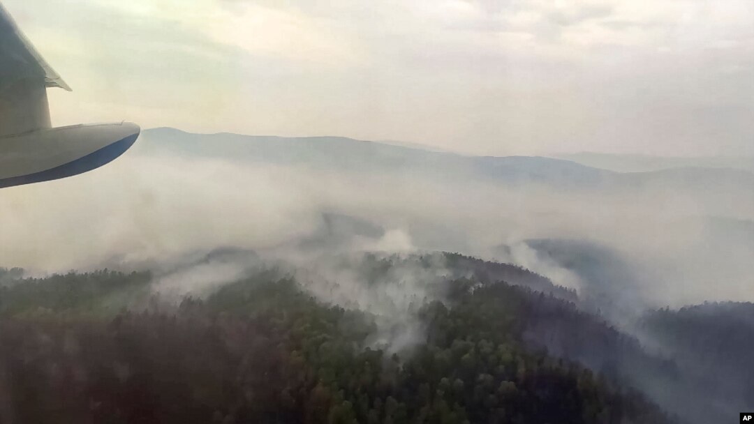 This image taken from video provided by Russian Emergency Ministry, shows a view of a forest fire from a Russian Emergency Ministry multipurpose amphibious aircraft in the Trans-Baikal National Park in Buryatia, southern Siberia, Russia, July 9, 2020.
