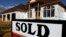 FILE -- A sold sign is posted in front of a new home in Springfield, Illinois.