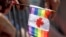 FILE - A rainbow flag with a Canadian emblem is held during a Pride Parade, in Miami Beach, Fla., April 7, 2019.
