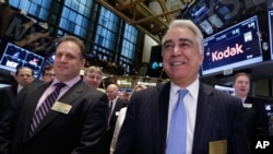 FILE - Kodak Chairman James Continenza, left, and then-CEO Antonio Perez visit the New York Stock Exchange trading floor, before ringing the opening bell, Jan. 8, 2014.