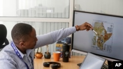 Kenneth Mwangi, a satellite information analyst at the Intergovernmental Authority on Development's Climate Prediction and Applications Center, shows a map predicting the movement of desert locust swarms, in Nairobi, Kenya, March 5, 2020.