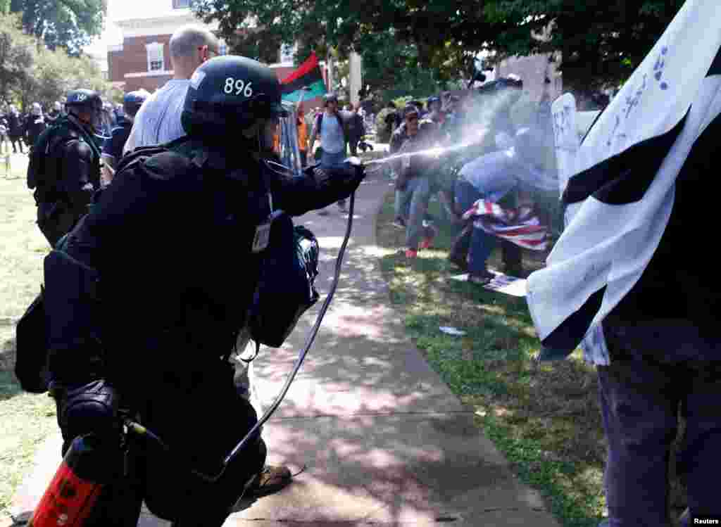 Virginia State Police use pepper spray as they move in to clear a clash between members of white nationalist protesters against a group of counterprotesters in Charlottesville, Va., Aug. 12, 2017. 