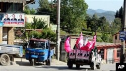 A vehicle covered with electoral posters moving around the Albanian capital Tirana, May 6, 2011