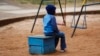 FILE - A child sits outside Nyumbani Children's Home in Nairobi, Kenya, Aug. 15, 2023. The orphanage cares for over 100 children with HIV, providing them with PEPFAR-supplied antiretroviral drugs. Funds for PEPFAR were among those included in a U.S. aid freeze, Jan. 24, 2025.