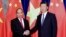 FILE - Chinese President Xi Jinping (right) poses with Vietnamese Prime Minister Nguyen Xuan Phuc prior to a meeting at Great Hall of the People in Beijing, Sept.13, 2016.