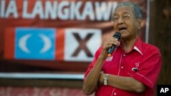 FILE - Former Malaysian leader Mahathir Mohamad speaks at a local community in Langkawi, Malaysia, April 27, 2018. In an unlikely comeback, he's switched sides in Malaysian politics, coming out of retirement to unite an opposition that’s seeking to end his former party’s 60-year hold on power and oust his protege, Prime Minister Najib Razak, in May 9 elections.