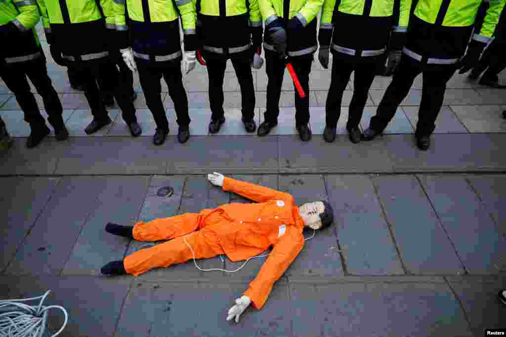 An effigy of North Korean leader Kim Jong Un is surrounded by police officers during an anti-North Korea protest in front of the U.S. embassy in Seoul, South Korea.