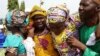 FILE - One of the newly released 82 Chibok school girls embraces her parents as she reunites with her family in Abuja, Nigeria, May 20, 2017. 