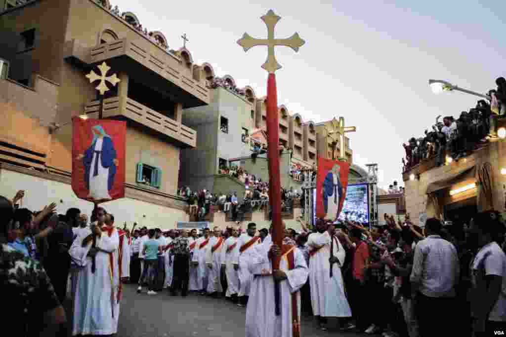 Umat Koptik mengelu-elukan para diakon saat mereka menuruni gunung sebagai ritual keagamaan untuk acara di Assiut, Mesir, 20 Agustus, 2017. (H. Elrasam/VOA)