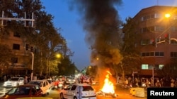 Motor milik anggota polisi tampak terbakar di tengah aksi protes antipemerintah di Teheran, Iran, pada 19 September 2022. (Foto: WANA (West Asia News Agency) via Reuters)