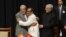 Indian Prime Minister Narinder Modi, left, and Jammu and Kashmir Deputy Chief Minister Nirmal Singh, center, embrace as Jammu and Kashmir Chief Minister Mufty Mohammed Sayeed looks on during a swearing-in ceremony of the state assembly in Jammu, March 1, 2015.