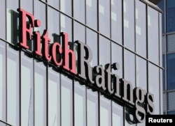 The Fitch Ratings logo hangs outside the company's offices at Canary Wharf financial district in London, March 3, 2016. Fitch downgraded the United States government's credit rating this week.