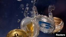 FILE - Illustration shows representation of cryptocurrency Bitcoin, Ethereum and Dash plunging into water