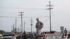 Military personnel and civilians wait in a parking lot outside the Fort Hood military base for updates about the shooting that occurred inside, April 2, 2014.