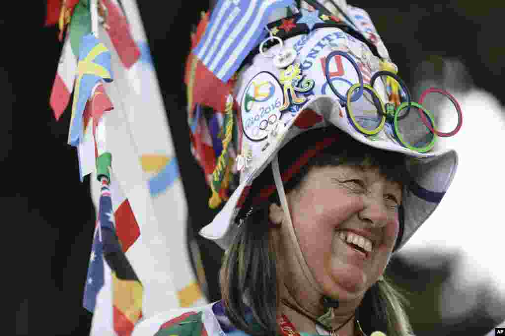 A fan from the United States smiles as she walks toward the Maracana Stadium ahead of the opening ceremony for the 2016 Summer Olympics in Rio de Janeiro, Brazil, Aug. 5, 2016.