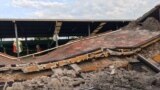 A car sits crushed, engulfed in a pile of rubble from a building felled by a 7.1 earthquake, in Jojutla, Morelos state, Mexico, Sept. 19, 2017. 