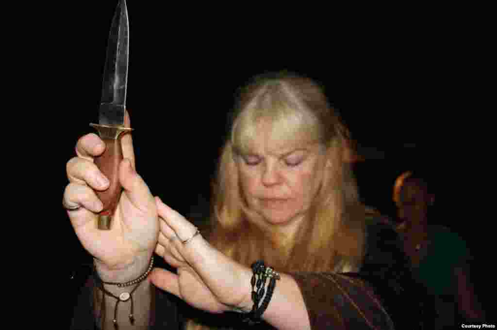 The high priestess holds up a ceremonial dagger to invoke aspects of&nbsp;the rites of ancient elders. &quot;Most of us in this coven come from ancient Celtic roots,&rdquo; she said.