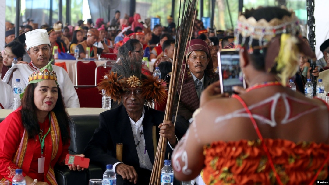 Participants take photos on the sidelines of an indigenous peoples gathering on Sumatra island, Indonesia, March 17, 2017.