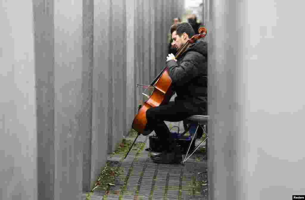 Slovenian Luka Sulic, a member of the Cellisten-Duo "2Cellos", plays cello at the Holocaust Memorial in Berlin, Germany.