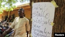 A man walks to receive his voter identification card in Senou, Mali, June 29, 2013.