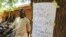 A man walks to receive his voter identification card in Senou, Mali, June 29, 2013.