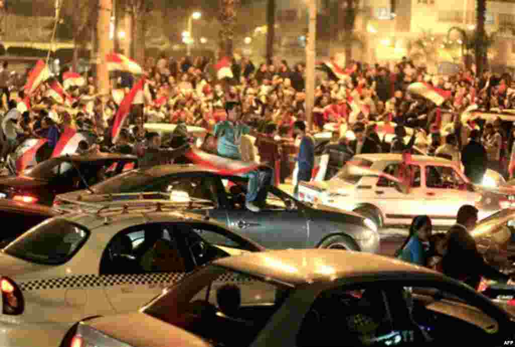 Egyptians celebrate after President Hosni Mubarak resigned and handed power to the military in Cairo, Egypt, Friday, Feb. 11, 2011. Egypt exploded with joy, tears, and relief after pro-democracy protesters brought down President Hosni Mubarak with a momen