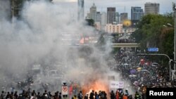 Anti-government demonstrators burn mock body bags, representing casualties of the COVID-19 outbreak and a puppet depicting Thai Prime Minister Prayuth Chan-ocha during an anti-government in Bangkok, Thailand, July 18, 2021.