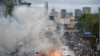 Anti-government demonstrators burn mock body bags, representing casualties of the COVID-19 outbreak and a puppet depicting Thai Prime Minister Prayuth Chan-ocha during an anti-government in Bangkok, Thailand, July 18, 2021.