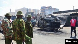 FILE — Police officers stand guard at the scene of an explosion at a makeshift gas cylinder refilling depot in Mradi estate, Embakasi district, in Nairobi, Kenya, February 2, 2024. 