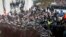 Protesters push a riot police line outside the parliament building in Chisinau, Moldova, Jan. 20, 2016. Hundreds of protesters broke through police lines on Wednesday to get into Moldova's parliament after it voted in a new prime minister.