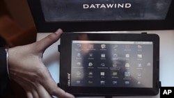 A DataWind representative displays the supercheap 'Aakash' Tablet computers during its launch in New Delhi, India. The $35 basic touchscreen tablet aimed at students can be used for functions like word processing, web browsing and video conferencing. 'Aa
