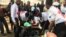 Zimbabwe Red Cross Society officials treat members of the opposition who were injured after clashes with the police in Harare, Aug. 16, 2019. (Columbus Mavhunga/VOA)