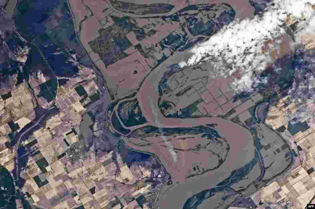 A NASA image shows the outlines of heavily flooded agricultural fields on the near Caruthersville, Missouri on the Mississippi river. (AP Photo/NASA)